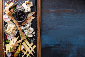 Cheese board served with jam and pear. Top view.  Copy space
