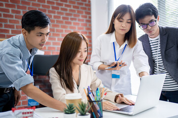 Group of young Asian businessmen gathered for an office meeting and brainstorming.