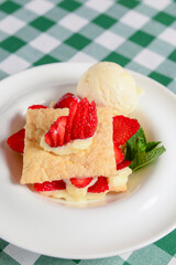 Napoleon cake with strawberries and vanilla ice cream. Italian cuisine concept, traditional Italian summer dessert.