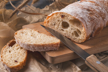 Crusty Ciabatta  bread ready to eat. Fresh Ciabatta bread on wooden cutting board.