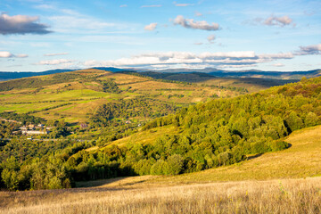 Fototapeta na wymiar beautiful rural landscape in autumn. field on hillside in mountains in evening light