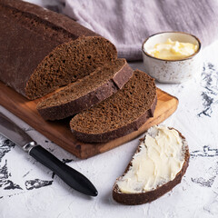 Closeup photo of sliced bread with butter.