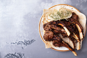 Tasty grilled lamb meat on a plate. Copy space. Top view