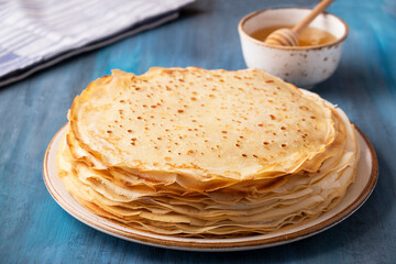 Delicious thin pancakes with honey.