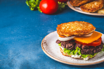 Delicious potato pancakes burger with meat. Dranburger. Copy space