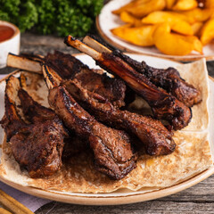 Grilled lamb chops on a plate. Mutton on a grill. Closeup