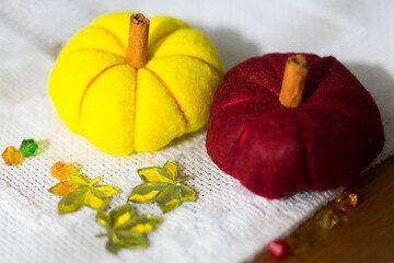 Decorative colorful pumpkins made from felt, threads and  cinnamon sticks 