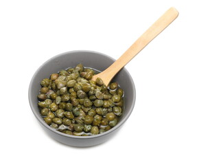 Capers in porcelain bowl with wooden spoon, edible flower buds isolated on white background