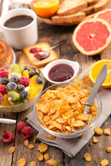 cornflake, fresh fruit, bread and coffee cup