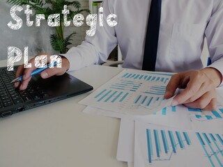 Financial concept about Strategic Plan with inscription on the piece of paper.