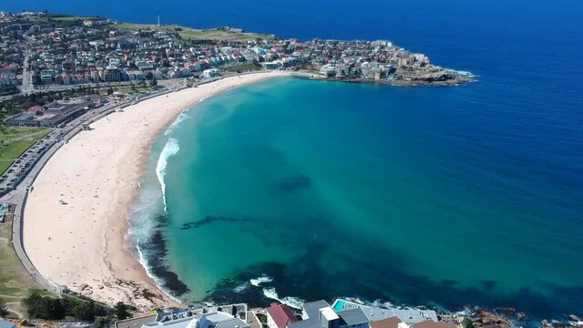 Panoramic drone aerial view of Bondi beach Sydney Australia. Turquoise blue water white sand and waves