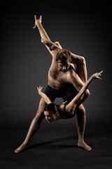 Ballet Dancers over Black Background. Acrobatic Ballet Couple Dance