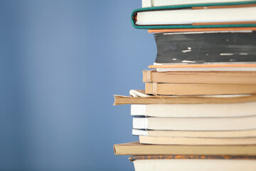 A stack of books in front of a blue background
