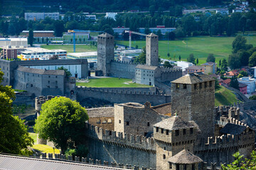 Summer landscape overlooking two Bellinzona Castles on Alpine foothills in Switzerland. Montebello Castle in foreground, Castelgrande behind