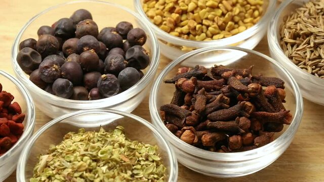 Glass bowls with a variation of dried spices close up