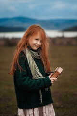 The girl plays the kalimba. Percussion instrument.