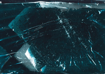 Cracked ice background. Frozen water surface. Teal blue scratched abstract texture with frost.
