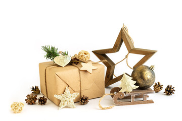 Gift box in craft organic paper, wooden star, Christstmas reusable sustainable recycled toys and bumps isolated on white background with copy space. Zero waste new year decor. Eco-friendly holidays
