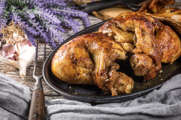Quarters of fried chicken in a cast iron skillet.