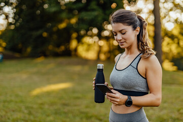 Holding a bottle of water.