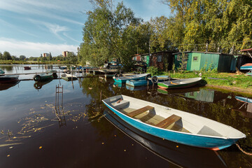 Fototapeta na wymiar Floating fishing village with boats at rest on a sunny autumn day.