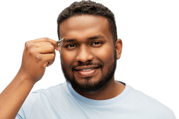grooming and people concept - smiling young african american man with tweezers tweezing his eyebrow over white background