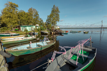 Fototapeta na wymiar Scenic panorama with old wooden fishing boats on a picturesque lake in Russia.