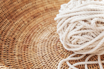 Fototapeta na wymiar Cotton rope for handmade macrame in a woven basket. Female hobby. Copy space