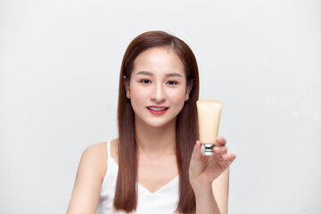 Beautiful Caucasian Woman Face Portrait holding and presenting cream tube product