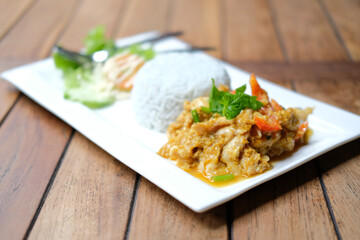 stir fried chicken curry sauce serving with rice and vegetable
