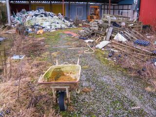 Garbage dump with a wheelbarrow in a industrial area