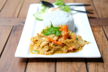 stir fried chicken curry sauce serving with rice and vegetable