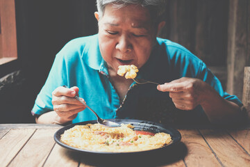 old asian elderly senior elder woman eating food at restaurant. mature lifestyle