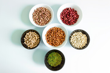 Phaseolus. Bright multi-colored beans, mung beans and chickpeas in ceramic cups. A complete source...