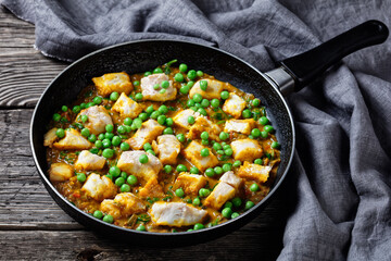 fish curry with green peas, top view