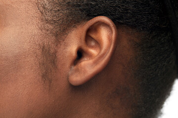 hearing, health and beauty concept - close up of african american woman's ear - obrazy, fototapety, plakaty