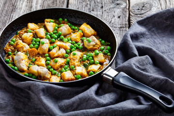 fish curry with green peas, top view