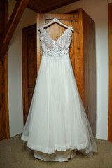 Fototapeta na wymiar Dress bride on shoulders in closet