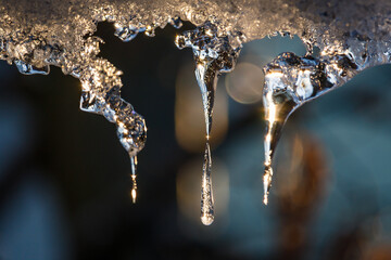 Obraz na płótnie Canvas icicles or ice stalactites backlit with the sun