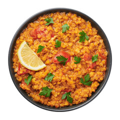 Red lentils dal in black bowl isolated on white background. Lentils tomato dhal is indian cuisine dish with lemon and ciliantro. Indian food. Asian vegetarian meal
