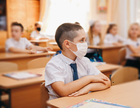 Group Of Kids In Masks For Coronavirus Prevention In School Classroom