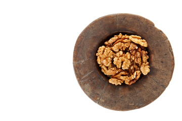 Walnuts in antique, wooden mortar.