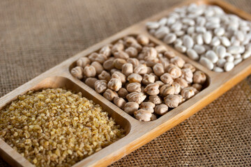 Wheat (Bulgur), chickpeas and white beans in the plate. Healthy and natural nutrition.