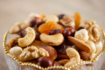 Mixed nuts in a glass plate. Healthy and natural nutrition .Cashew, Almond,, Hazelnut,, Fig,, Walnut,, Apricot,, Raisin,, Blueberry.