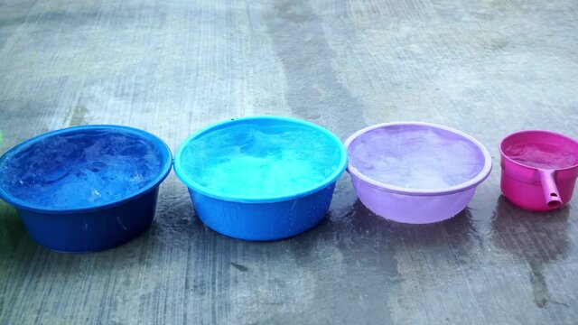 row of bucket collecting rain water to reuse
