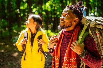 latin american man and hispanic woman in a forest having a rest
