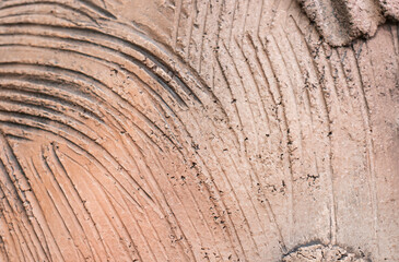 Wavy clay wall texture and clay house background.