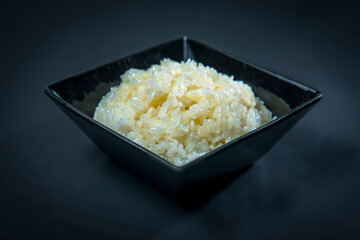 Boiled White Rice In A Black Square Bowl