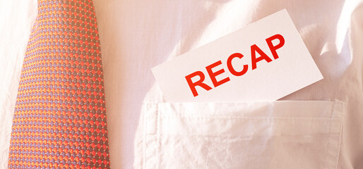 RECAP word on white card paper in a pocket of white shirt of a businessman with red tie. summary...