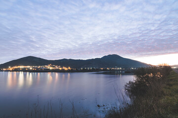 night scene of landscape reflected in lagoon